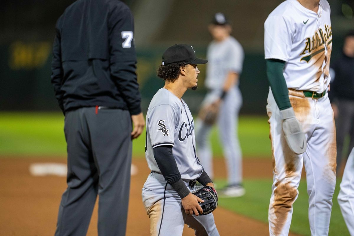 Aug 5, 2024; Oakland, California, USA;  Chicago White Sox third baseman Miguel Vargas (20) reacts after Oakland Athletics second baseman Zack Gelof (20) is called safe by umpire Brian O'Nora (7) during the eighth inning at Oakland-Alameda County Coliseum. Mandatory Credit: Neville E. Guard-USA TODAY Sports