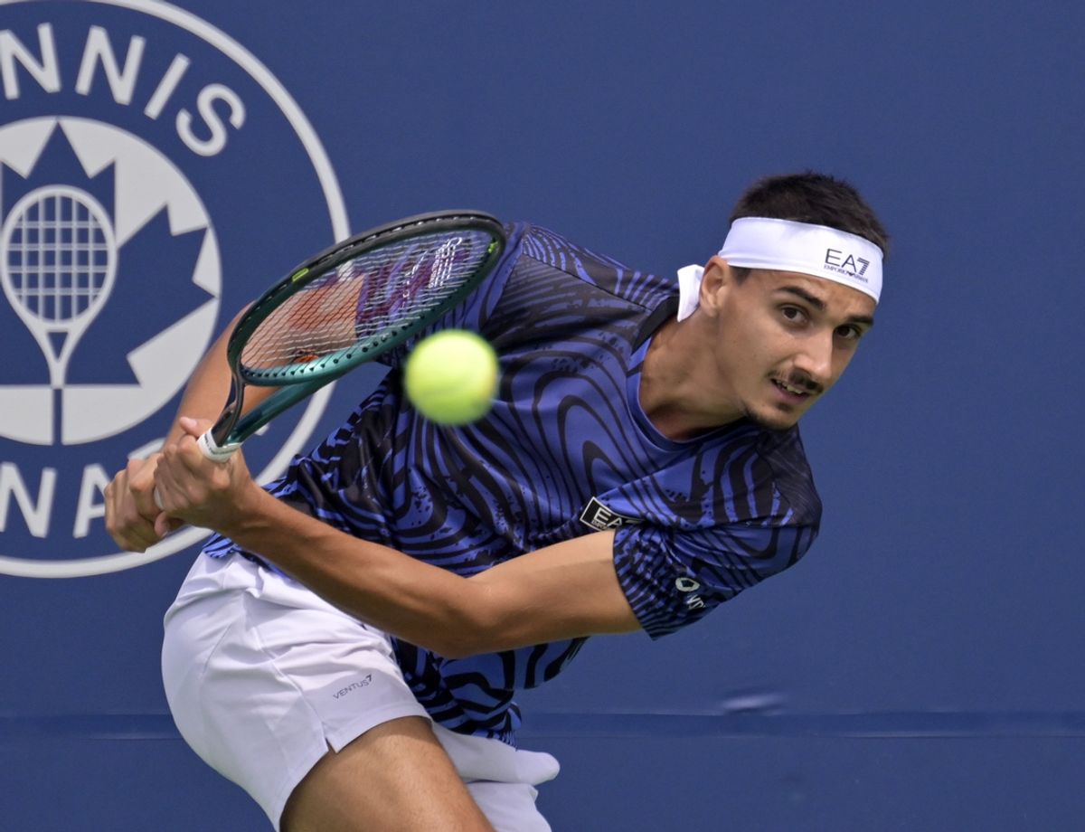 Aug 6, 2024; Montreal, Quebec, Canada; Lorenzo Sonego (ITA) hits a backhand against Tallon Griekspoor (NED) (not pictured) in first round play at IGA Stadium. Mandatory Credit: Eric Bolte-USA TODAY Sports
