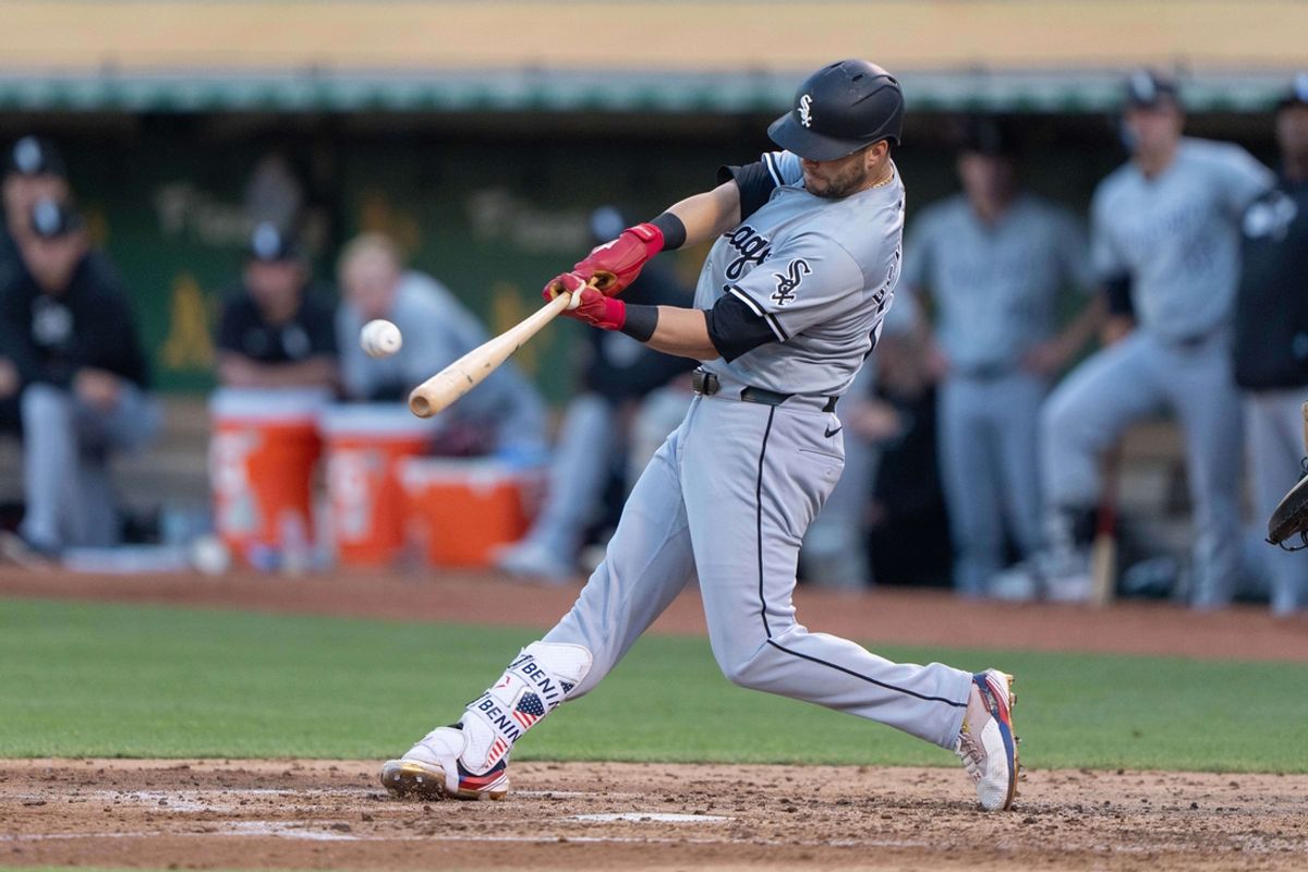Aug 6, 2024; Oakland, California, USA;  Chicago White Sox outfielder Andrew Benintendi (23) hits a two run home run during the fourth inning against the Oakland Athletics at Oakland-Alameda County Coliseum. Mandatory Credit: Stan Szeto-USA TODAY Sports