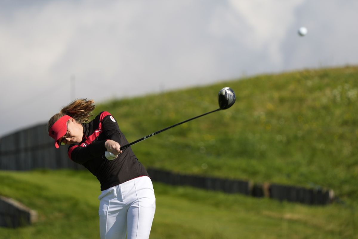 Aug 7, 2024; Saint-Quentin-en-Yvelines, France; Brooke Henderson (CAN) hits her tee shot on the 3rd hole in the first round of women's individual stroke play during the Paris 2024 Olympic Summer Games at Le Golf National. Mandatory Credit: Katie Goodale-Imagn Images