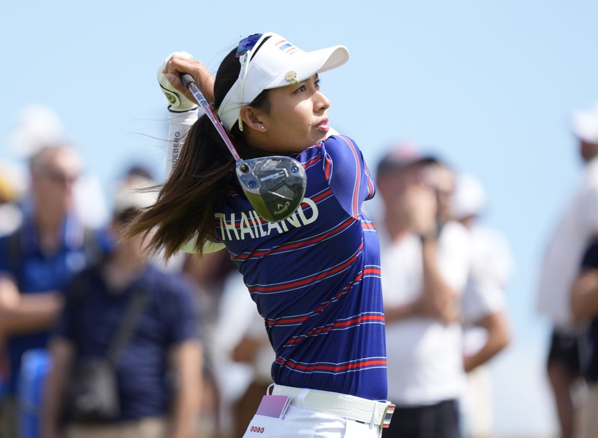 Aug 7, 2024; Saint-Quentin-en-Yvelines, France; Atthaya Thitikul (THA) hits her tee shot on the 12th hole in the first round of women's individual stroke play during the Paris 2024 Olympic Summer Games at Le Golf National. Mandatory Credit: Katie Goodale-Imagn Images