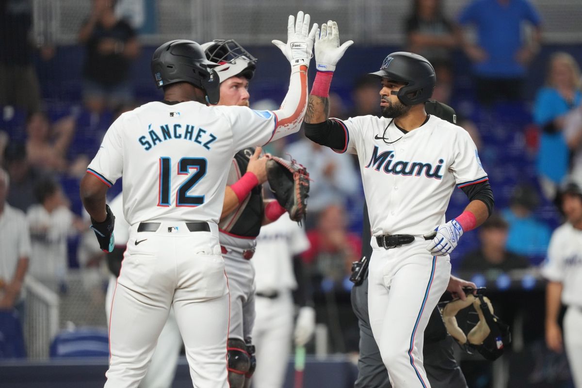 Aug 7, 2024; Miami, Florida, USA;  Miami Marlins left fielder Derek Hill, right, is congratulated by right fielder Jesús Sánchez (12) after hitting a grand slam in the first inning against the Cincinnati Reds at loanDepot Park. Mandatory Credit: Jim Rassol-USA TODAY Sports