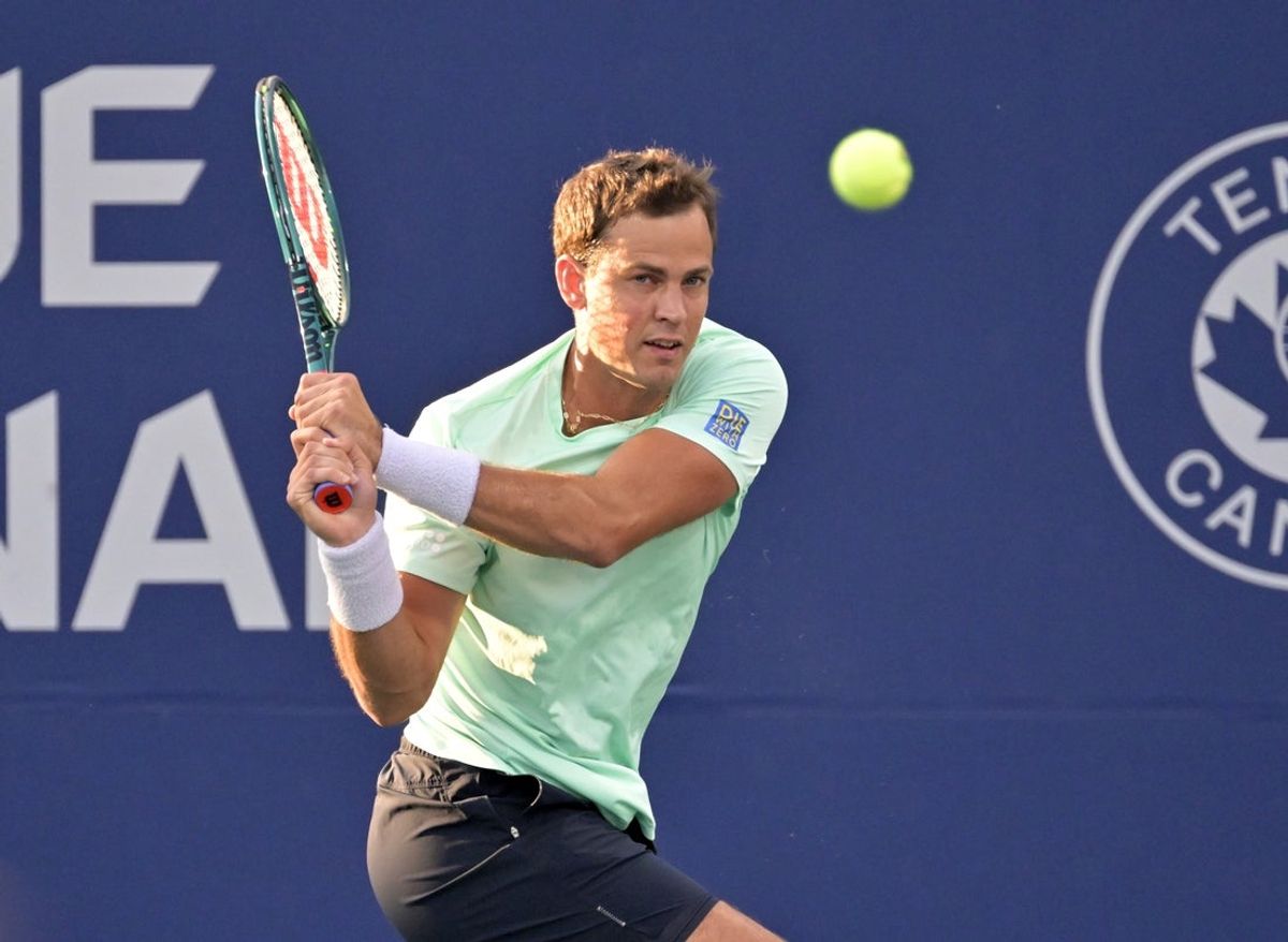 Aug 7, 2024; Montreal, Quebec, Canada; Vasek Pospisil (CAN) hits a backhand against Sebastian Korda (USA) (not pictured) in first round play at IGA Stadium. Mandatory Credit: Eric Bolte-Imagn Images