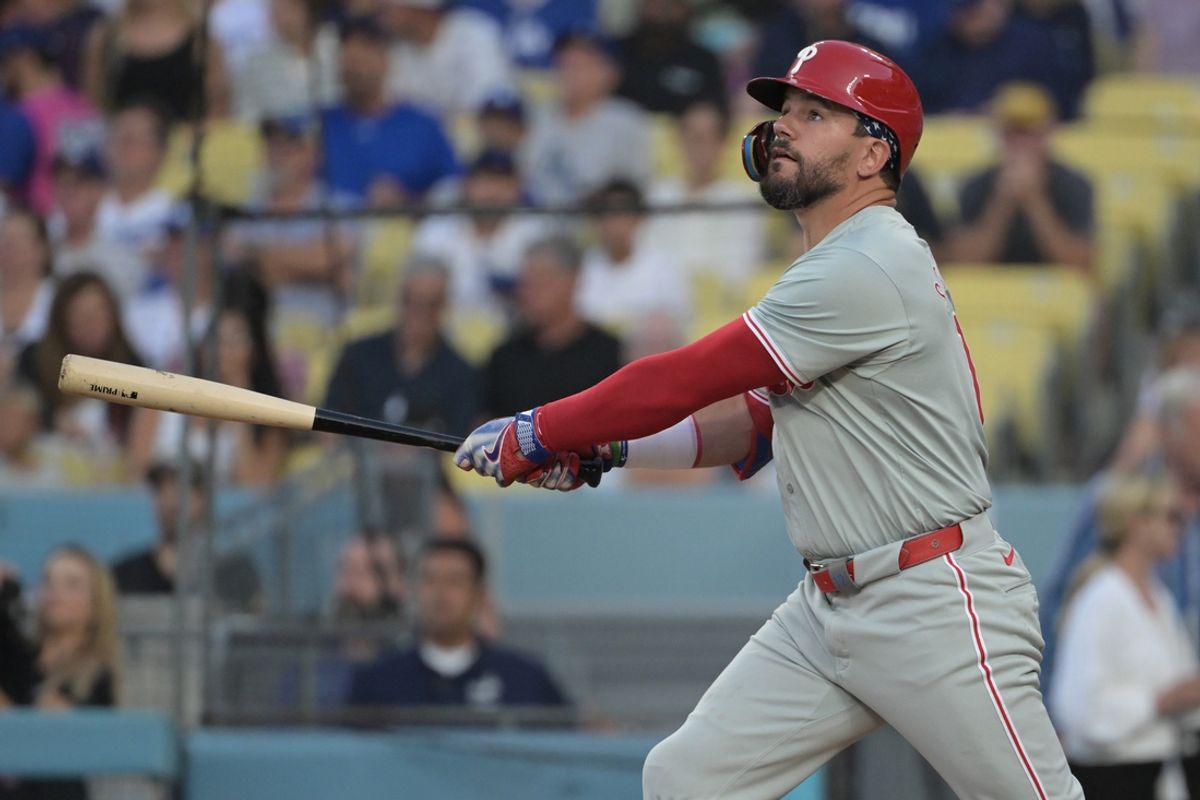 Aug 7, 2024; Los Angeles, California, USA;  Philadelphia Phillies designated hitter Kyle Schwarber (12) hits a solo home run in the first inning against the Los Angeles Dodgers at Dodger Stadium. Mandatory Credit: Jayne Kamin-Oncea-USA TODAY Sports