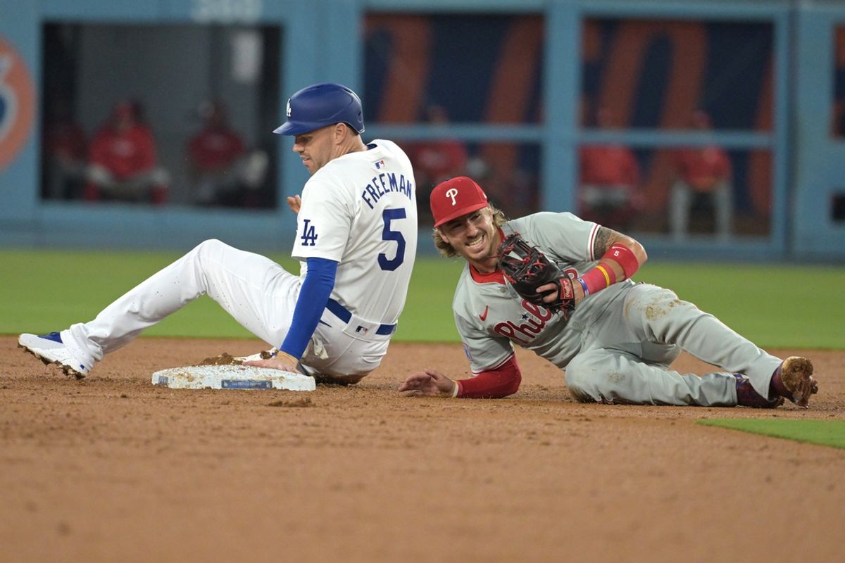 Aug 7, 2024; Los Angeles, California, USA;  Los Angeles Dodgers first baseman Freddie Freeman (5) is tagged out at second by Philadelphia Phillies second baseman Bryson Stott (5) in the second inning at Dodger Stadium. Mandatory Credit: Jayne Kamin-Oncea-USA TODAY Sports