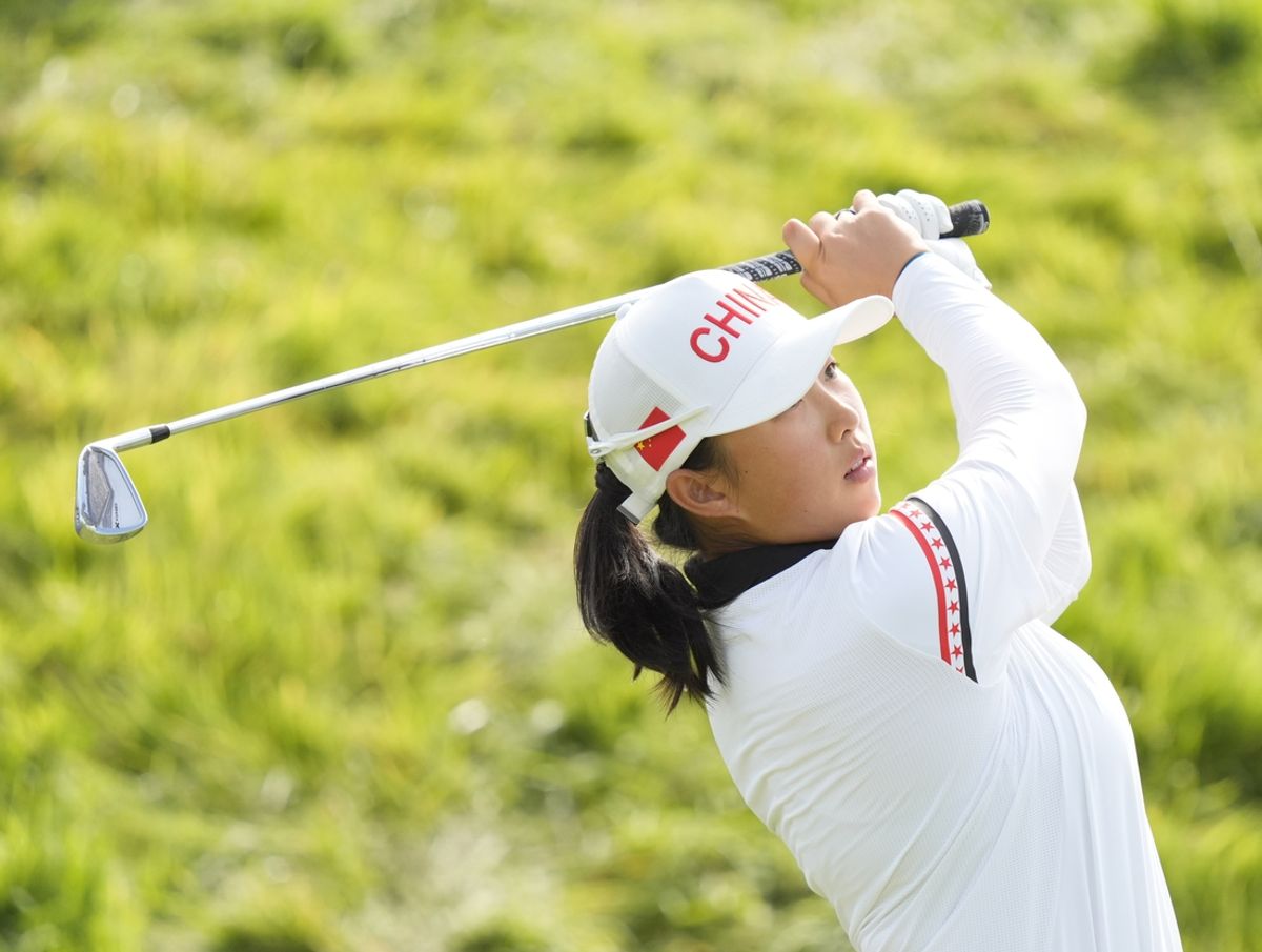 Aug 8, 2024; Saint-Quentin-en-Yvelines, France; Ruoning Yin (CHN) hits her tee shot on the 16th hole in the second round in women's individual stroke play during the Paris 2024 Olympic Summer Games at Le Golf National. Mandatory Credit: Katie Goodale-Imagn Images