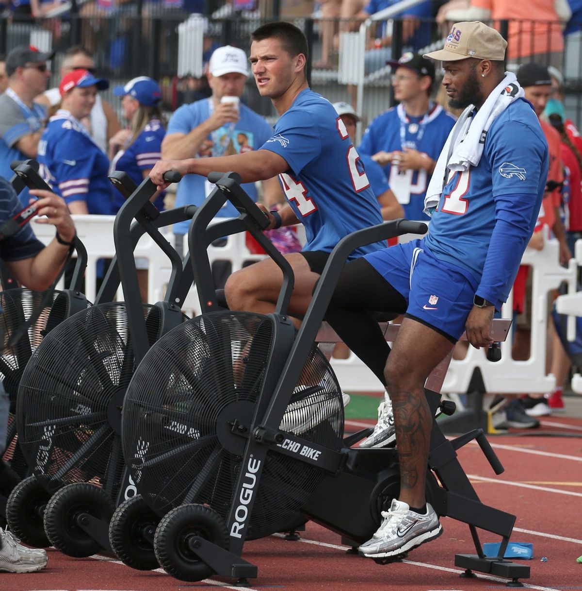 Injured Bills Cole Bishop and Mike Edwards hit the conditioning bikes as they watch practice from the sidelines.