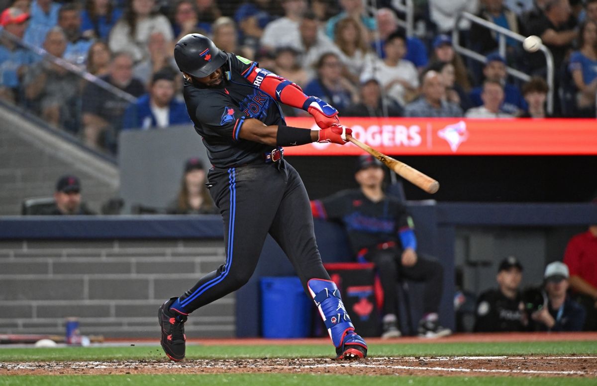 Aug 8, 2024; Toronto, Ontario, CAN; Toronto Blue Jays first base Vladimir Guerrero Jr. (27) hits a two run home run in the fifth inning against the Baltimore Orioles at Rogers Centre. Mandatory Credit: Gerry Angus-USA TODAY Sports