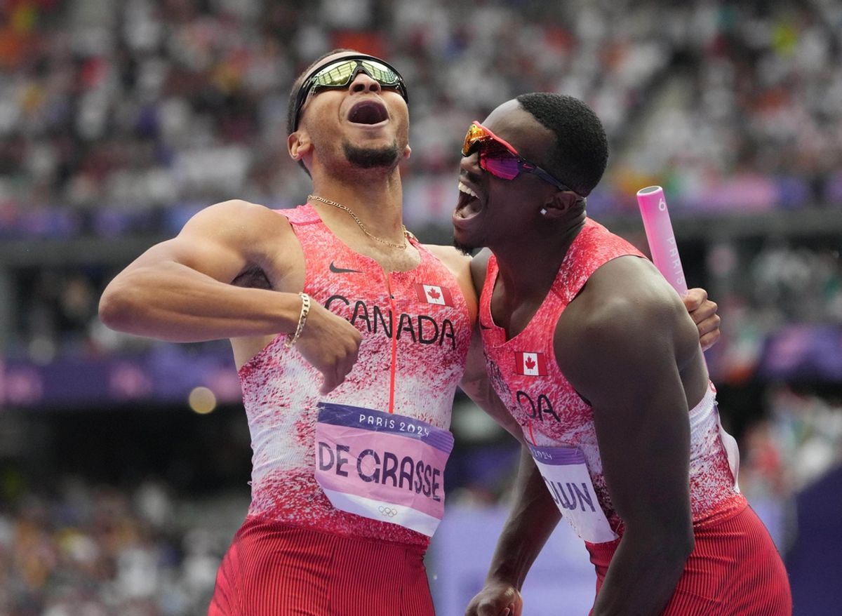 Aug 9, 2024; Saint-Denis, FRANCE;  Andre de Grasse (CAN) and Aaron Brown (CAN) celebrate after winning the men's 4x100m final during the Paris 2024 Olympic Summer Games at Stade de France. Mandatory Credit: Kirby Lee-USA TODAY Sports