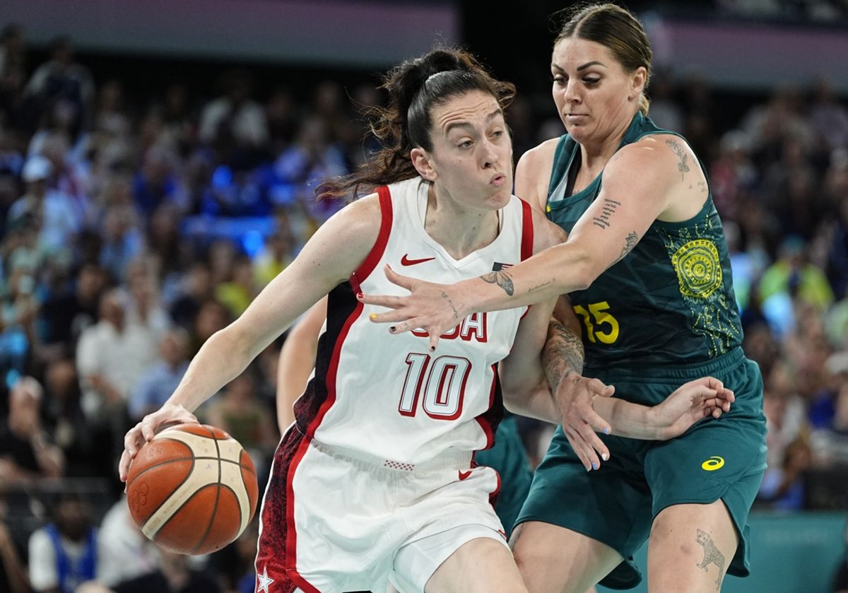 Aug 9, 2024; Paris, France; United States power forward Breanna Stewart (10) is defended by Australia forward Cayla George (15)  in a women's basketball semifinal game during the Paris 2024 Olympic Summer Games at Accor Arena. Mandatory Credit: Sarah Phipps-USA TODAY Sports