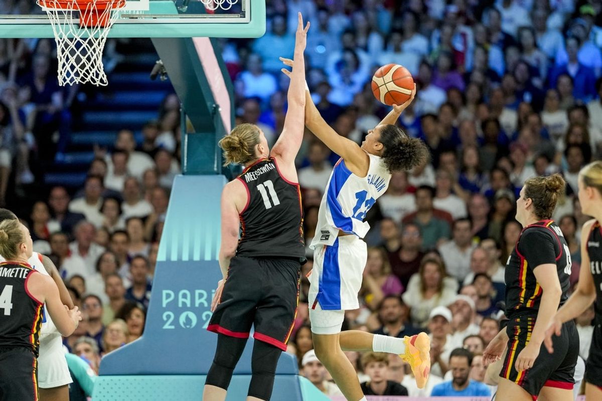 Aug 9, 2024; Paris, France; France forward Janelle Salaun (13) jumps to shoot while Belgium power forward Emma Meesseman (11) jumps to block in a women's basketball semifinal game during the Paris 2024 Olympic Summer Games at Accor Arena. Mandatory Credit: Kyle Terada-Imagn Images