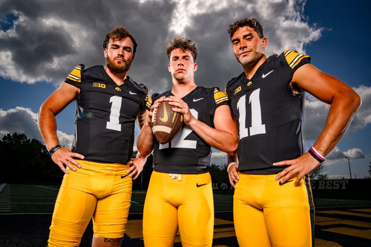 Quarterbacks Brendan Sullivan (1) Cade McNamara (12) and Marco Lainez (11) stand for a photo during Iowa football media day in Iowa City, Friday, Aug. 9, 2024.