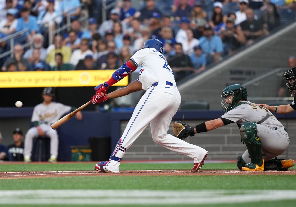 Aug 9, 2024; Toronto, Ontario, CAN; Toronto Blue Jays first baseman Vladimir Guerrero Jr. (27) hits a double against the Oakland Athletics during the first inning at Rogers Centre. Mandatory Credit: Nick Turchiaro-USA TODAY Sports