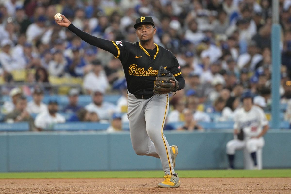 Aug 9, 2024; Los Angeles, California, USA; Pittsburgh Pirates third baseman Ke'Bryan Hayes (13) throws out Los Angeles Dodgers shortstop Miguel Rojas (11) at first in the third inning at Dodger Stadium. Mandatory Credit: Jayne Kamin-Oncea-USA TODAY Sports