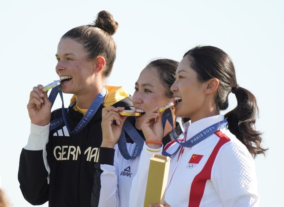 Aug 10, 2024; Saint-Quentin-en-Yvelines, France;  Lydia Ko (NZL), Esther Henseleit (GER) and Xiyu Janet Lin (CHN) at the medal ceremony after women's individual stroke play during the Paris 2024 Olympic Summer Games at Le Golf National. Mandatory Credit: Katie Goodale-Imagn Images