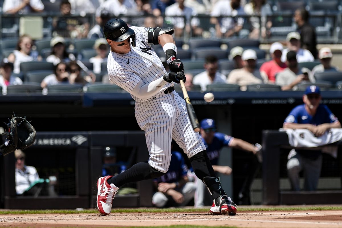 Aug 10, 2024; Bronx, New York, USA; New York Yankees outfielder Aaron Judge (99) hits a single against the Texas Rangers during the first inning at Yankee Stadium. Mandatory Credit: John Jones-USA TODAY Sports