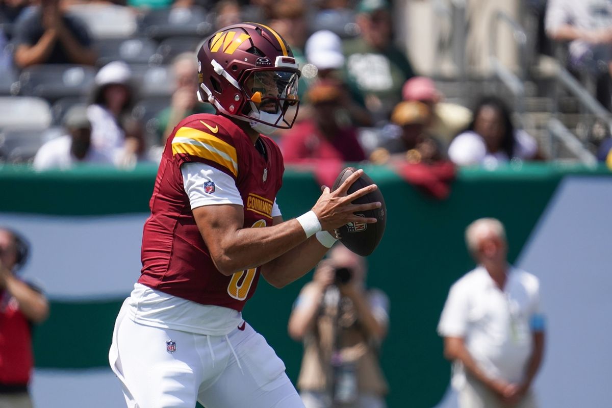 Aug 10, 2024; East Rutherford, New Jersey, USA; Washington Commanders quarterback Marcus Mariota (0) receives a snap during the first quarter against the New York Jets at MetLife Stadium. Mandatory Credit: Lucas Boland-Imagn Images