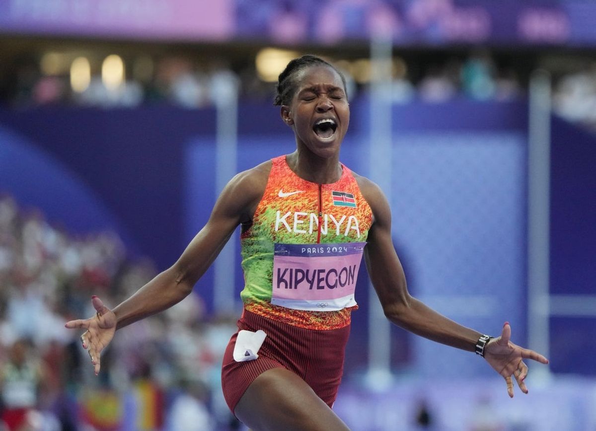 Aug 10, 2024; Saint-Denis, FRANCE;  Faith Kipyegon (KEN) celebrates after the men's 5000m final during the Paris 2024 Olympic Summer Games at Stade de France. Mandatory Credit: Kirby Lee-Imagn Images