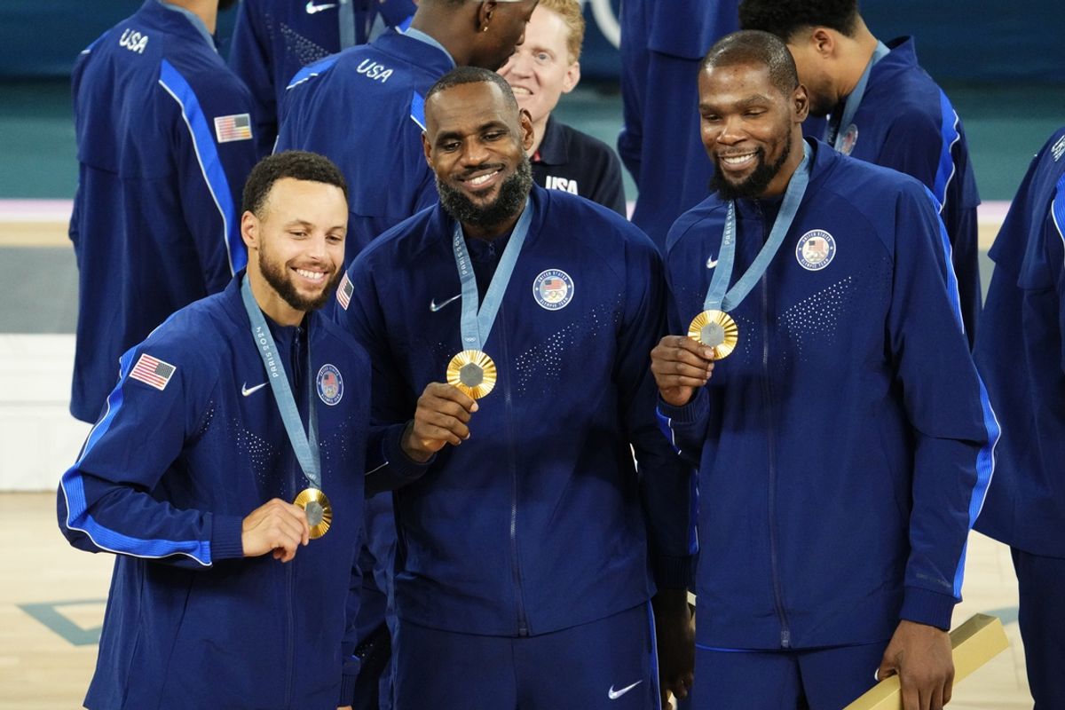 Aug 10, 2024; Paris, France; United States shooting guard Stephen Curry (4) and guard LeBron James (6) and guard Kevin Durant (7) celebrate with their gold medals on the podium after defeating France in the men's basketball gold medal game during the Paris 2024 Olympic Summer Games at Accor Arena. Mandatory Credit: Rob Schumacher-Imagn Images