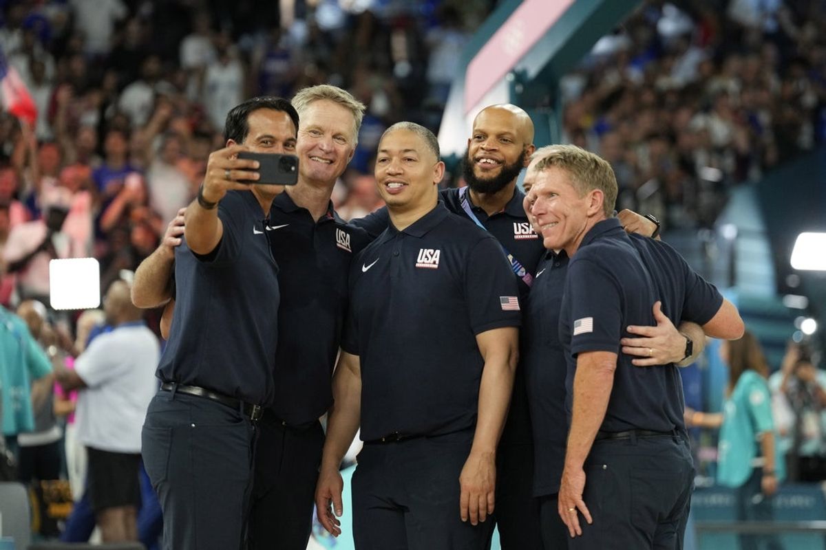 Aug 10, 2024; Paris, France;  United States assistant coach Erik Spoelstra takes a selfie with head coach Steve Kerr and assistant coach Tyronn Lue and assistant coach Mark Few in the men's basketball gold medal game during the Paris 2024 Olympic Summer Games at Accor Arena. Mandatory Credit: Kyle Terada-Imagn Images