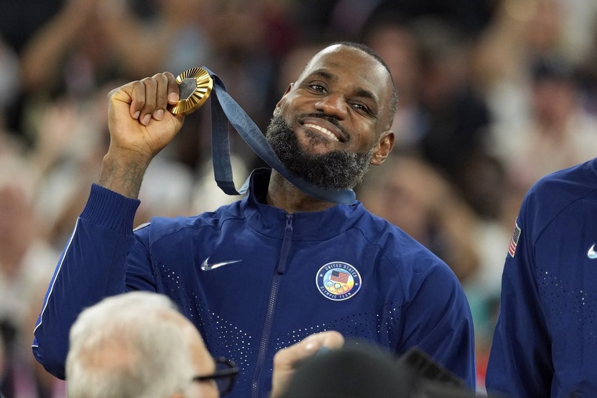 Aug 10, 2024; Paris, France; United States guard LeBron James (6) celebrates with the gold medal after the game against France in the men's basketball gold medal game during the Paris 2024 Olympic Summer Games at Accor Arena. Mandatory Credit: Kyle Terada-Imagn Images