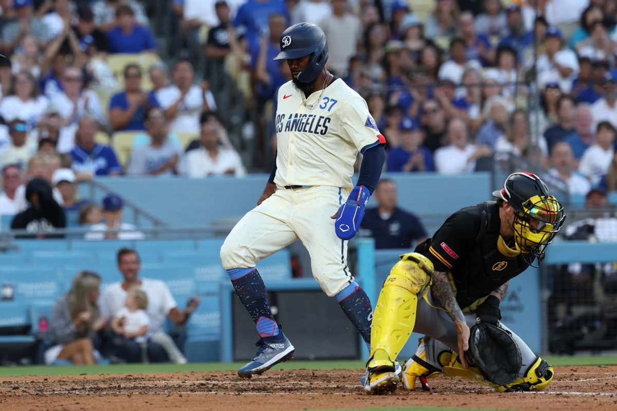 Aug 10, 2024; Los Angeles, California, USA;  Los Angeles Dodgers left fielder Teoscar Hernandez (37) scores a run ahead of a tag from Pittsburgh Pirates catcher Yasmani Grandal (6) during the third inning at Dodger Stadium. Mandatory Credit: Kiyoshi Mio-USA TODAY Sports