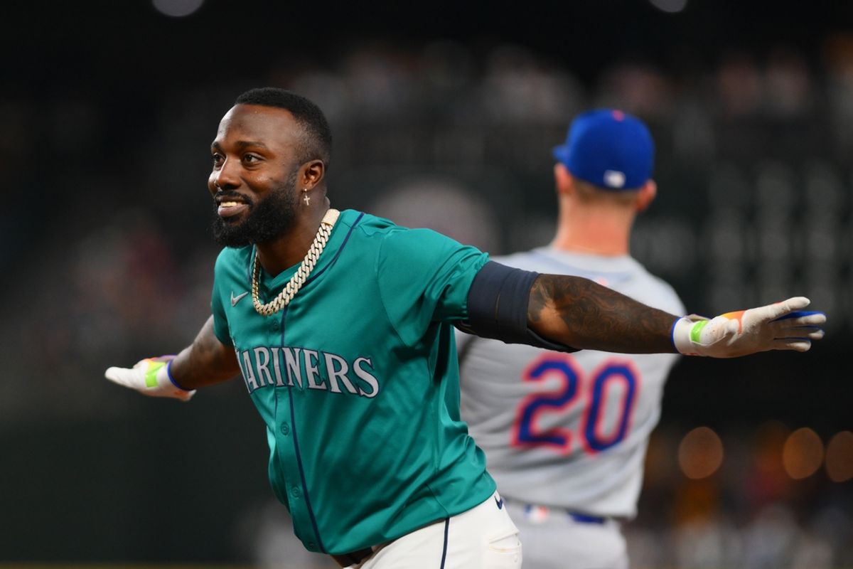 Aug 10, 2024; Seattle, Washington, USA; Seattle Mariners left fielder Randy Arozarena (56) signals safe after hitting a single against the New York Mets during the seventh inning at T-Mobile Park. Mandatory Credit: Steven Bisig-USA TODAY Sports