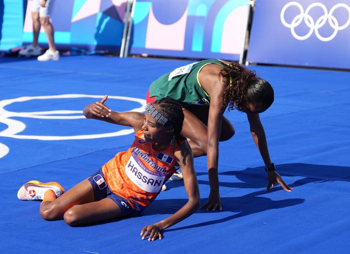 Aug 11, 2024; Paris, France; Sifan Hassan (NED) and Tigst Assefa (ETH) fall to the ground after finishing first and second in the women's marathon during the Paris 2024 Olympic Summer Games. Mandatory Credit: Kirby Lee-USA TODAY Sports