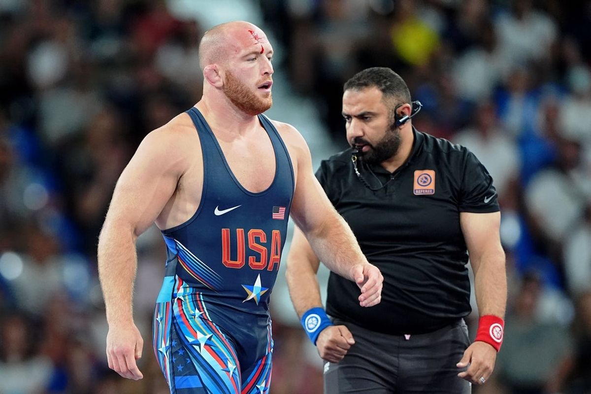 Aug 11, 2024; Paris, France; Kyle Frederick Snyder (USA) bleeds from his head in his loss to Amirali Azarpira (IRI) in a menís freestyle 97kg bronze medal match during the Paris 2024 Olympic Summer Games at Champ-de-Mars Arena. Mandatory Credit: Grace Hollars-Imagn Images