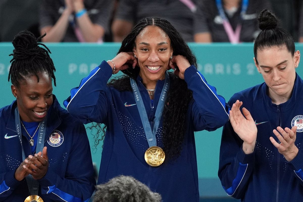 Aug 11, 2024; Paris, France; United States forward A'Ja Wilson (9) celebrates on the podium after defeating France in the women’s basketball gold medal game during the Paris 2024 Olympic Summer Games at Accor Arena. Mandatory Credit: James Lang-USA TODAY Sports