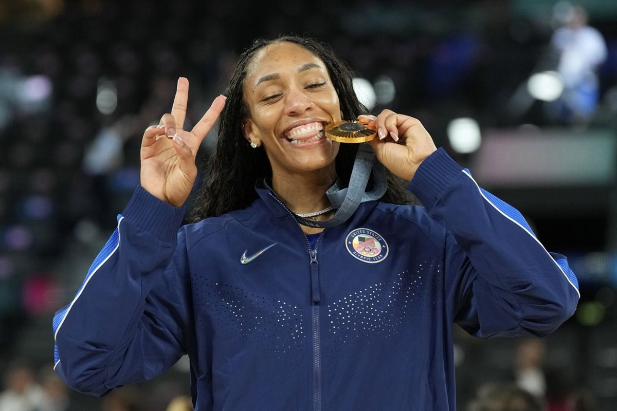 Aug 11, 2024; Paris, France; United States forward A'Ja Wilson (9) celebrates with the gold medal after defeating France in the women's gold medal game during the Paris 2024 Olympic Summer Games at Accor Arena. Mandatory Credit: Kyle Terada-Imagn Images