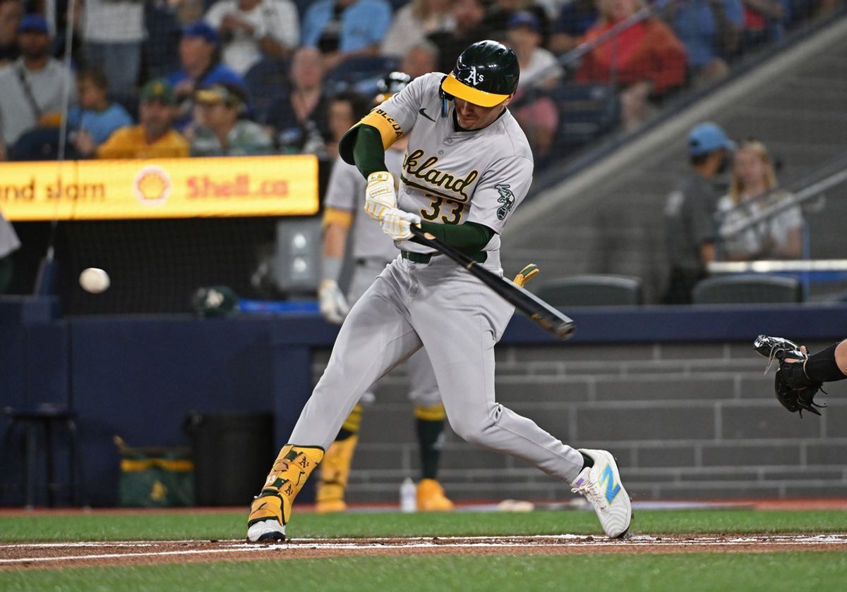 Aug 11, 2024; Toronto, Ontario, CAN; Oakland Athletics centre field JJ Bleday (33) hits a two run home run in the first inning against the Toronto Blue Jays at Rogers Centre. Mandatory Credit: Gerry Angus-USA TODAY Sports