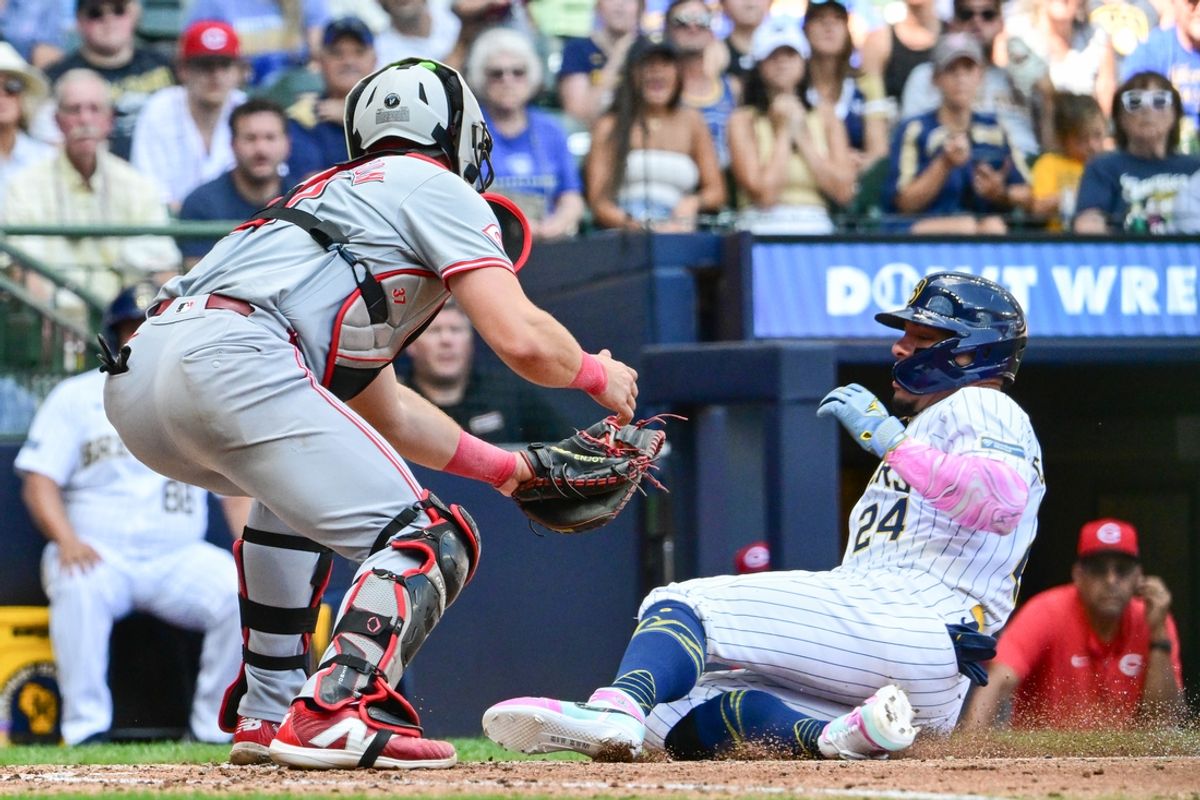 Aug 11, 2024; Milwaukee, Wisconsin, USA; Cincinnati Reds catcher Tyler Stephenson (37) tags out Milwaukee Brewers designated hitter William Contreras (24) trying to score in the sixth inning at American Family Field. Mandatory Credit: Benny Sieu-USA TODAY Sports