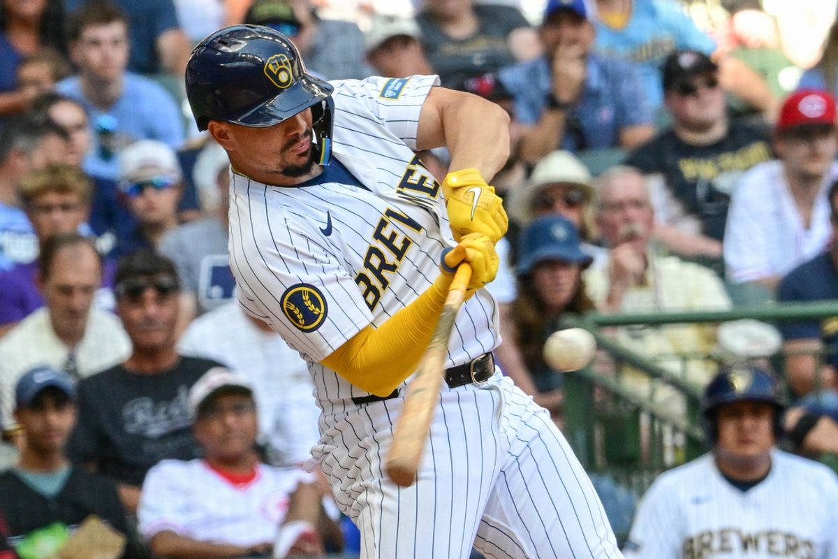 Aug 11, 2024; Milwaukee, Wisconsin, USA; Milwaukee Brewers shortstop Willy Adames (27) hits a single to drive in a run in the sixth inning against the Cincinnati Reds at American Family Field. Mandatory Credit: Benny Sieu-Imagn Images