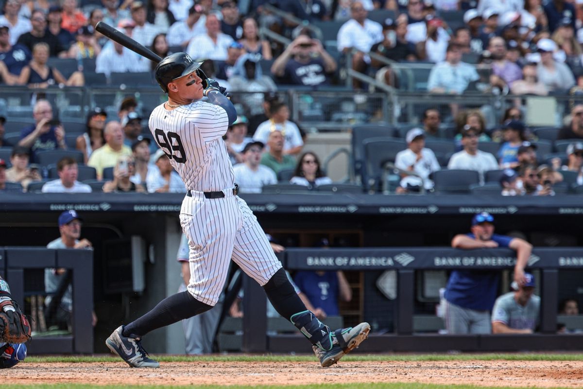 Aug 11, 2024; Bronx, New York, USA; New York Yankees center fielder Aaron Judge (99) hits a solo home run during the seventh inning against the Texas Rangers at Yankee Stadium. Mandatory Credit: Vincent Carchietta-USA TODAY Sports