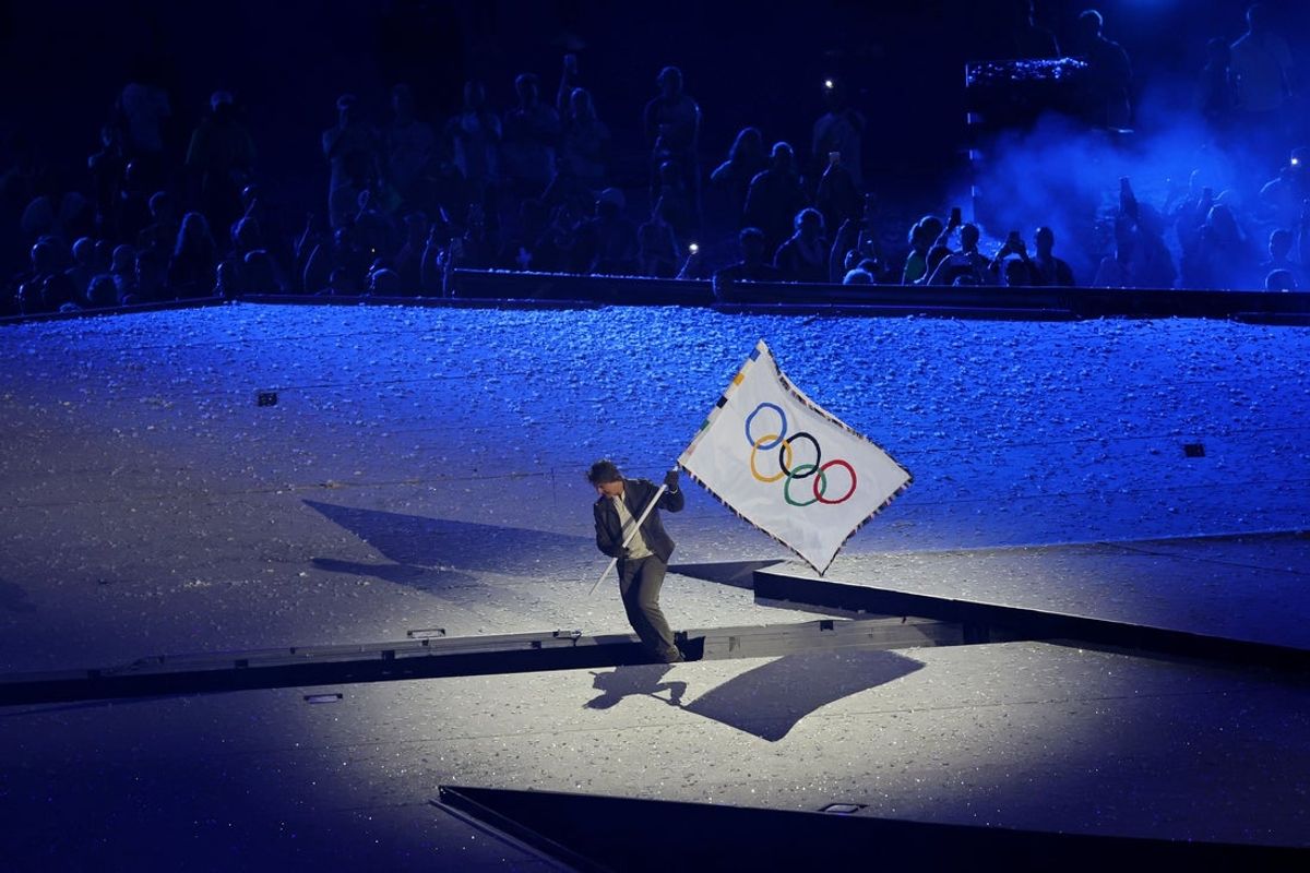Aug 11, 2024; Saint-Denis, France; Tom Cruise carries the Olympic flag during the closing ceremony for the Paris 2024 Olympic Summer Games at Stade de France. Mandatory Credit: Yukihito Taguchi-Imagn Images