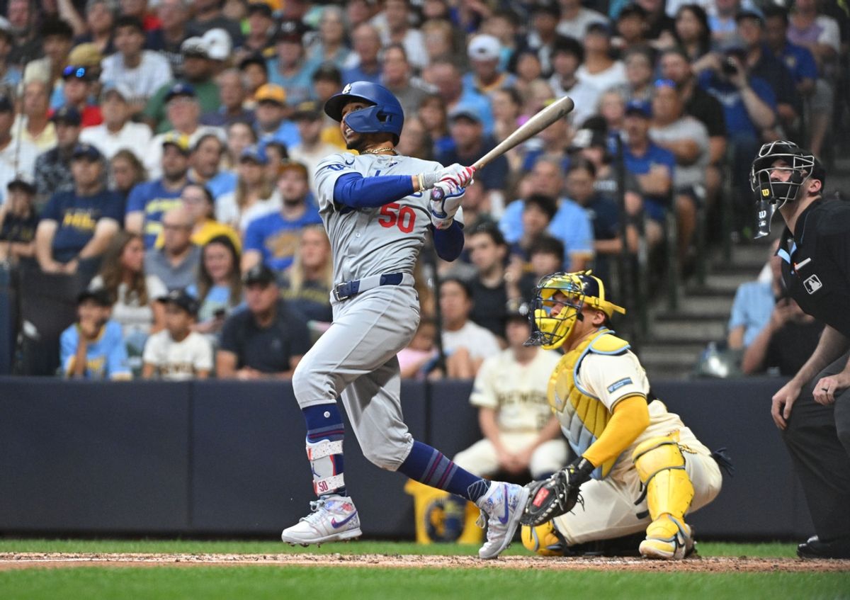 Aug 12, 2024; Milwaukee, Wisconsin, USA; Los Angeles Dodgers right field Mookie Betts (50) watches his home run go out over the wall against the Milwaukee Brewers at American Family Field. Mandatory Credit: Michael McLoone-USA TODAY Sports