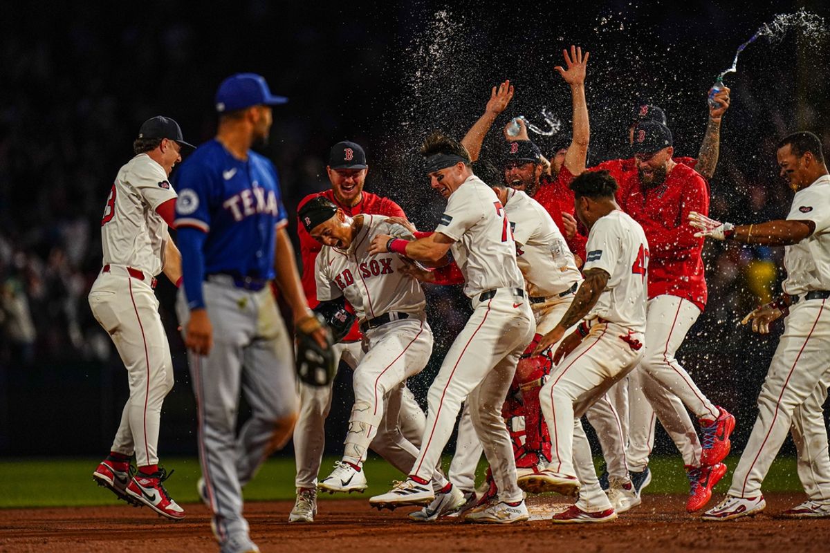 Aug 12, 2024; Boston, Massachusetts, USA; Boston Red Sox left fielder Rob Refsnyder (30) is congratulated after singling to center field to drive in the winning run against the Texas Rangers in the tenth inning at Fenway Park. Mandatory Credit: David Butler II-USA TODAY Sports