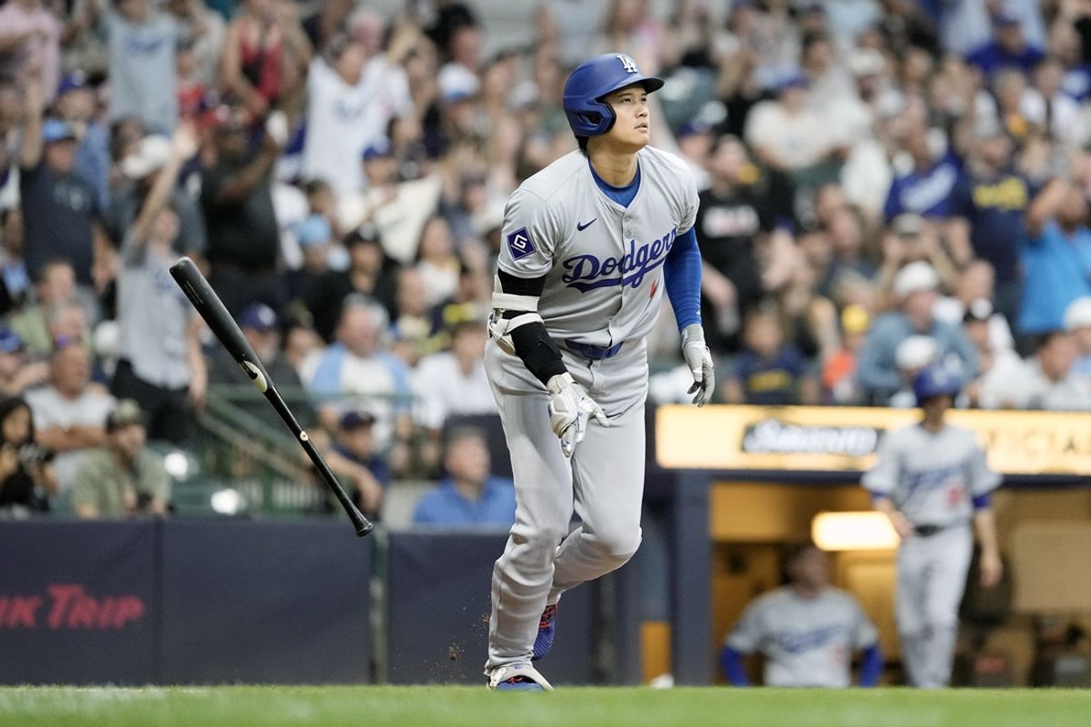 Aug 13, 2024; Milwaukee, Wisconsin, USA;  Los Angeles Dodgers designated hitter Shohei Ohtani (17) flips his bat away after hitting a home run during the third inning against the Milwaukee Brewers at American Family Field. Mandatory Credit: Jeff Hanisch-USA TODAY Sports