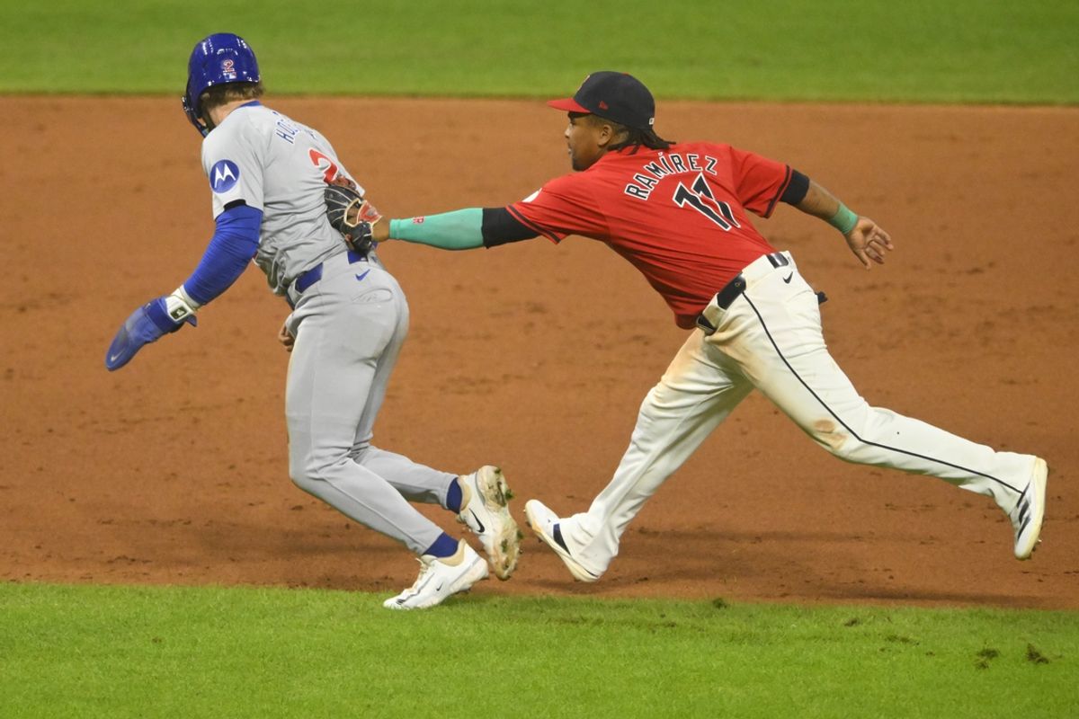 Aug 13, 2024; Cleveland, Ohio, USA; Chicago Cubs second baseman Nico Hoerner (2) is tagged out by Cleveland Guardians third baseman Jose Ramirez (11) to end the game in the ninth inning at Progressive Field. Mandatory Credit: David Richard-USA TODAY Sports
