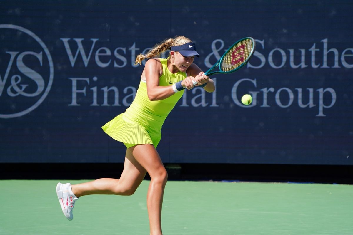Mirra Andreeva makes a hit to Emma Navarro in the women’s singles round 1 during the Cincinnati Open, Wednesday, Aug. 14, 2024, at the Lindner Family Tennis Center in Mason. Andreeva won 2-6, 2-6.
