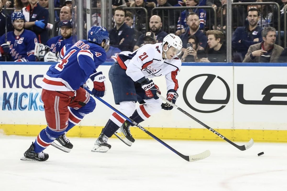 Dec 27, 2023; New York, New York, USA; Washington Capitals center Aliaksei Protas (21) skates past New York Rangers defenseman Braden Schneider (4) in the first period at Madison Square Garden.