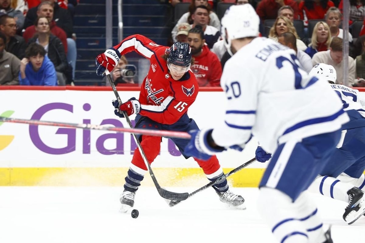 Mar 20, 2024; Washington, District of Columbia, USA; Washington Capitals left wing Sonny Milano (15) controls the puck in front of Toronto Maple Leafs defenseman Joel Edmundson (20) during the first period at Capital One Arena.