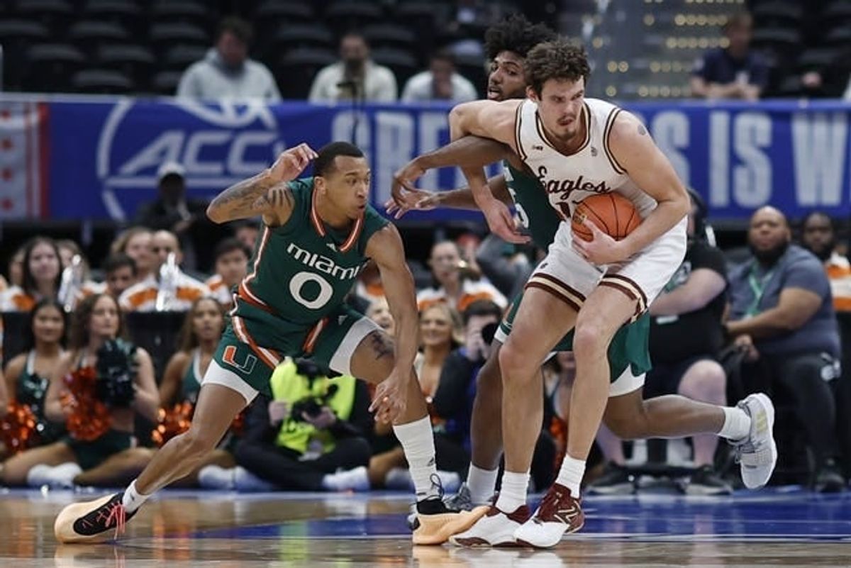 Mar 12, 2024; Washington, D.C., USA; Boston College Eagles forward Quinten Post (12) drives to the basket as Miami (Fl) Hurricanes guard Matthew Cleveland (0) and Hurricanes forward Norchad Omier (15) defend in the first half at Capital One Arena.