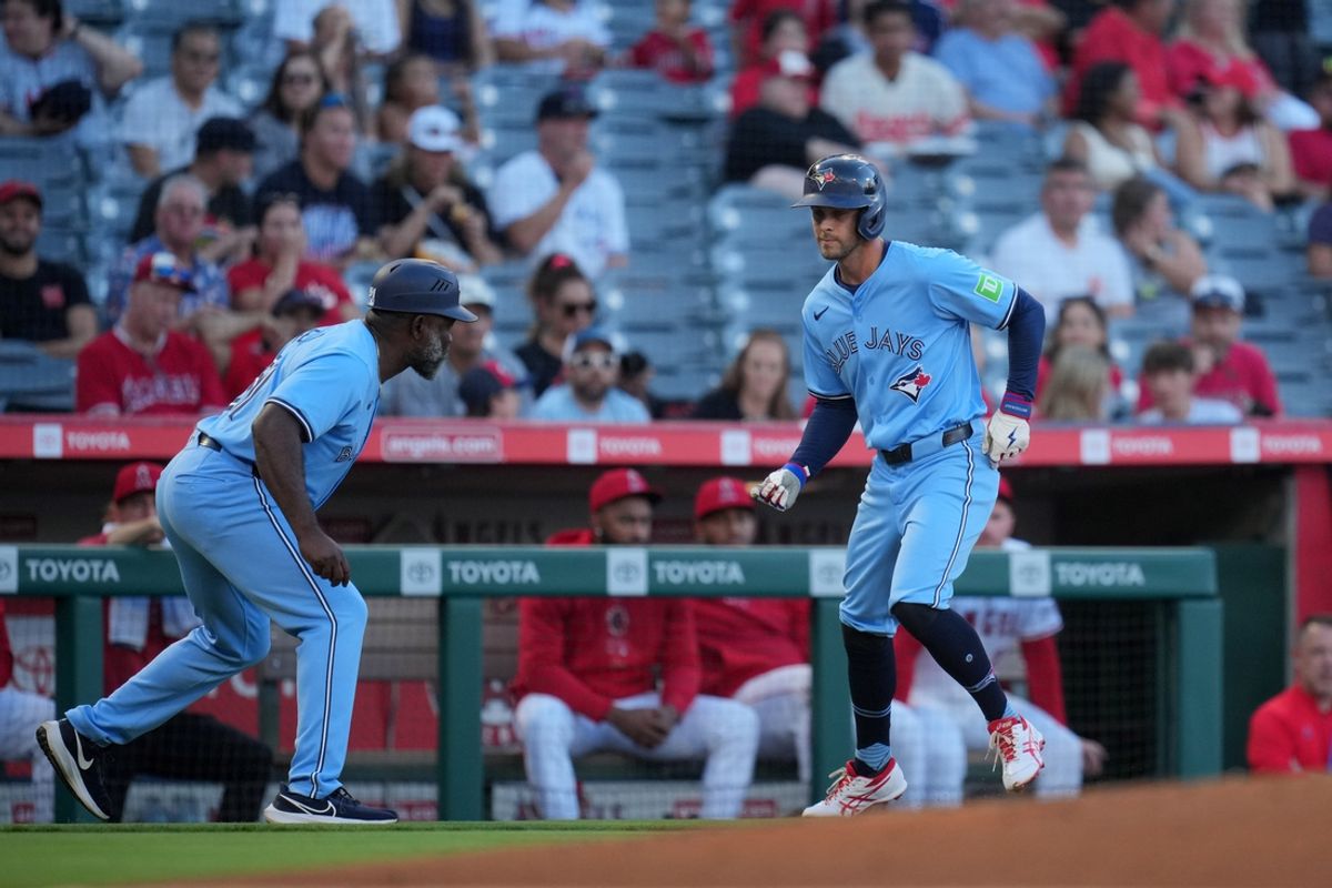 Aug 14, 2024; Anaheim, California, USA; Toronto Blue Jays shortstop Ernie Clement (28) celebrates with third base coach Carlos Febles (51) after hitting a two-run home run in the second inning against the Los Angeles Angels at Angel Stadium. Mandatory Credit: Kirby Lee-USA TODAY Sports