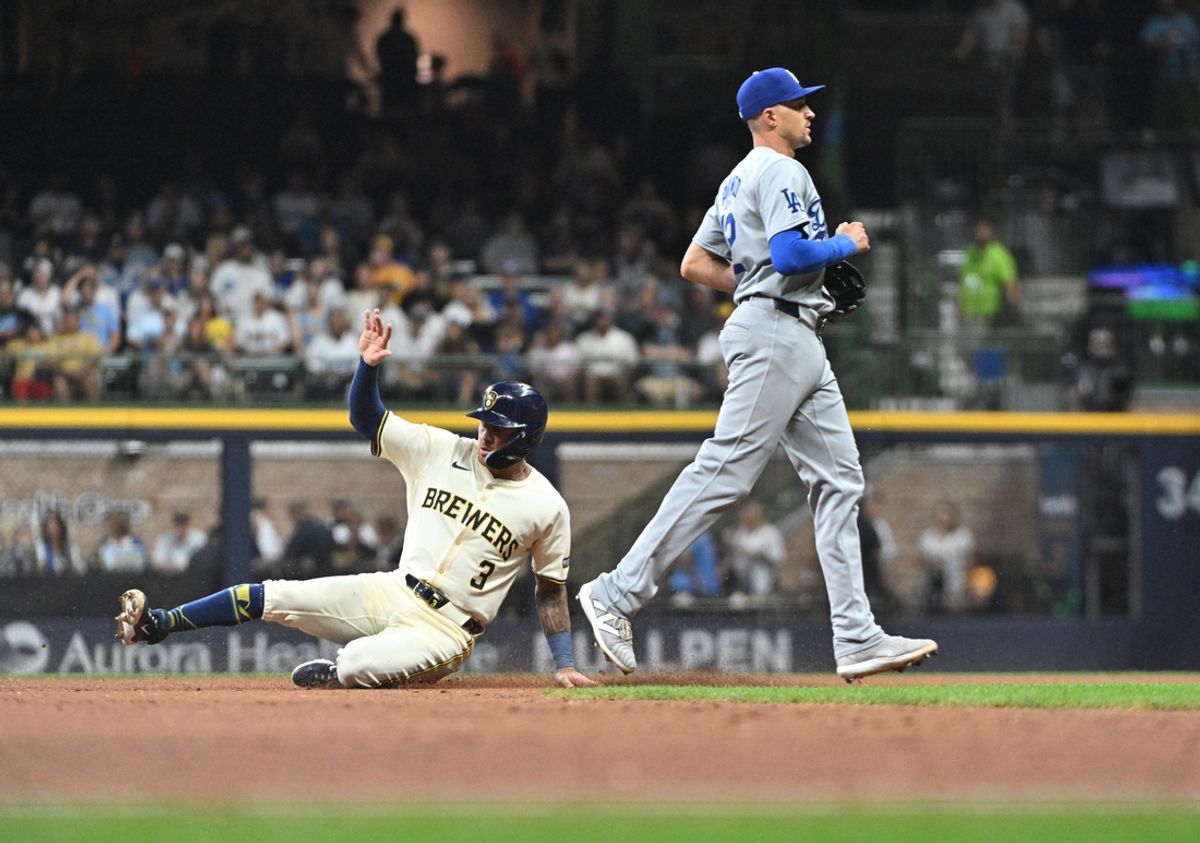 Aug 14, 2024; Milwaukee, Wisconsin, USA; Milwaukee Brewers third base Joey Ortiz (3) slides into second base safely with no play by Los Angeles Dodgers shortstop Nick Ahmed (12) in the fourth inning at American Family Field. Mandatory Credit: Michael McLoone-USA TODAY Sports
