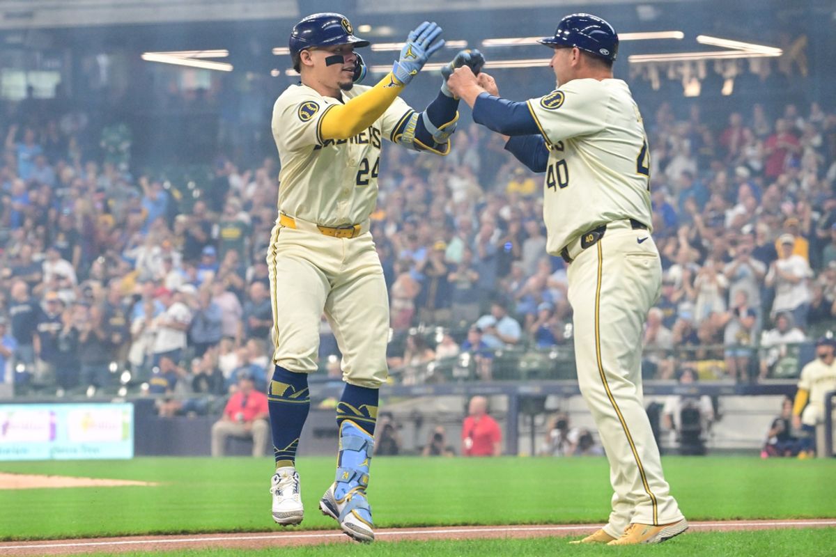 Aug 15, 2024; Milwaukee, Wisconsin, USA; Milwaukee Brewers catcher William Contreras (24) celebrates with third base coach Jason Lane after hitting a solo home run against the Los Angeles Dodgers in the first inning at American Family Field. Mandatory Credit: Benny Sieu-USA TODAY Sports