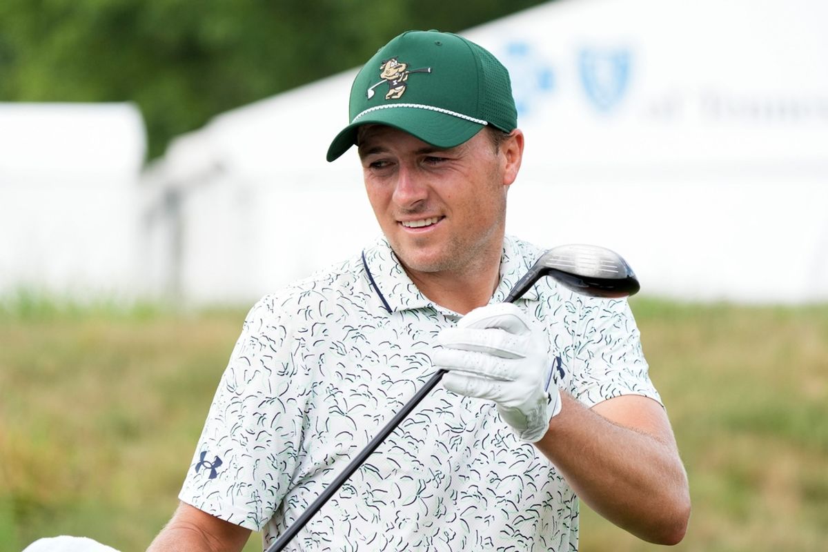 Jordan Spieth hands his driver to his caddy as he walks down the fairway on the ninth hole on the first day of the FedEx St. Jude Championship at TPC Southwind in Memphis, Tenn., on Thursday, August 15, 2024.