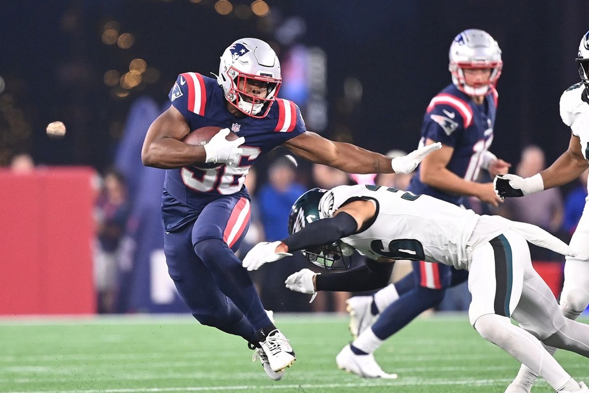 Aug 15, 2024; Foxborough, MA, USA; New England Patriots running back Kevin Harris (36) avoids a tackle by Philadelphia Eagles safety Tristin McCollum (36) during the first half at Gillette Stadium. Mandatory Credit: Eric Canha-USA TODAY Sports