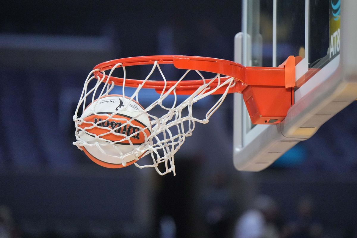 Aug 15, 2024; Los Angeles, California, USA; A WNBA official Wilson Evo NXT basketball approaches the rim and net at Crypto.com Arena. Mandatory Credit: Kirby Lee-Imagn Images
